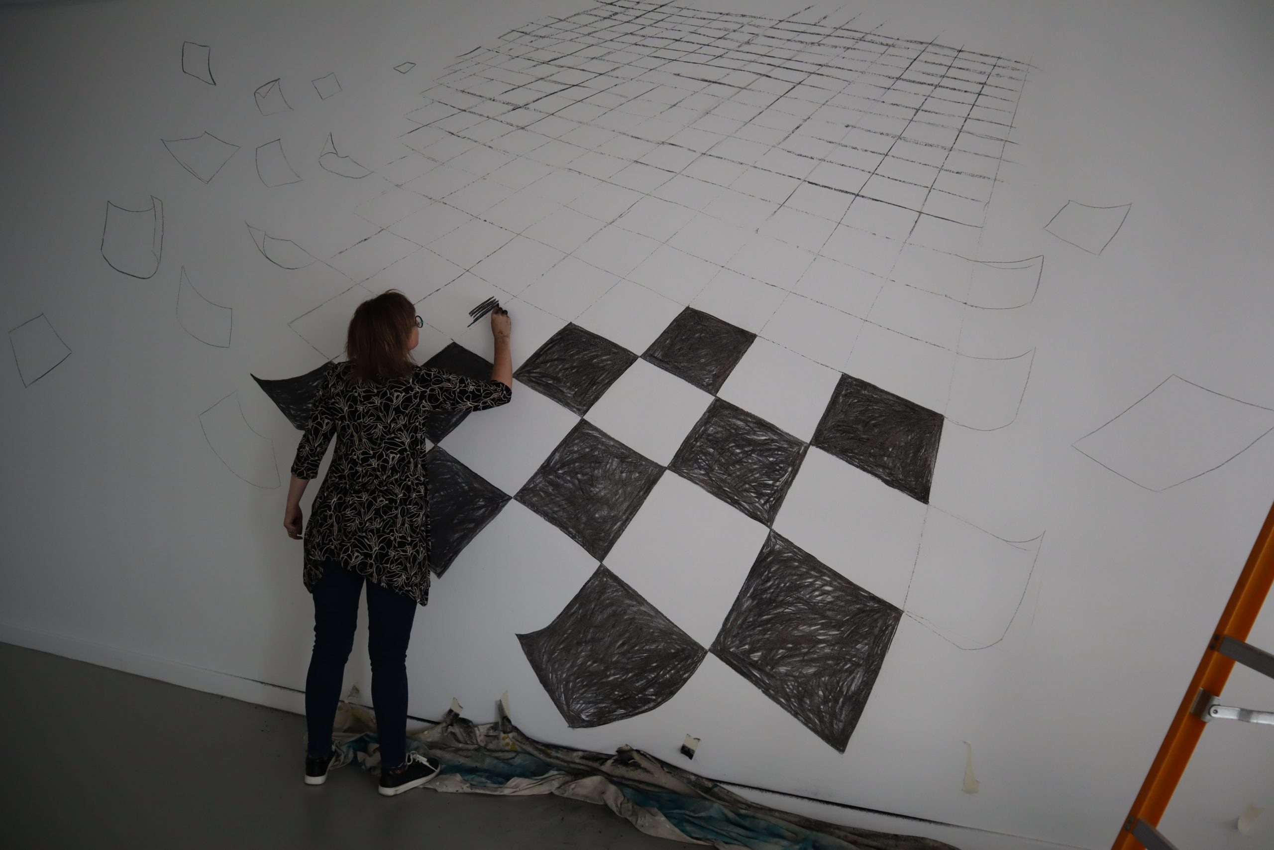 Shana James in the process of drawing on the Gallery Wall